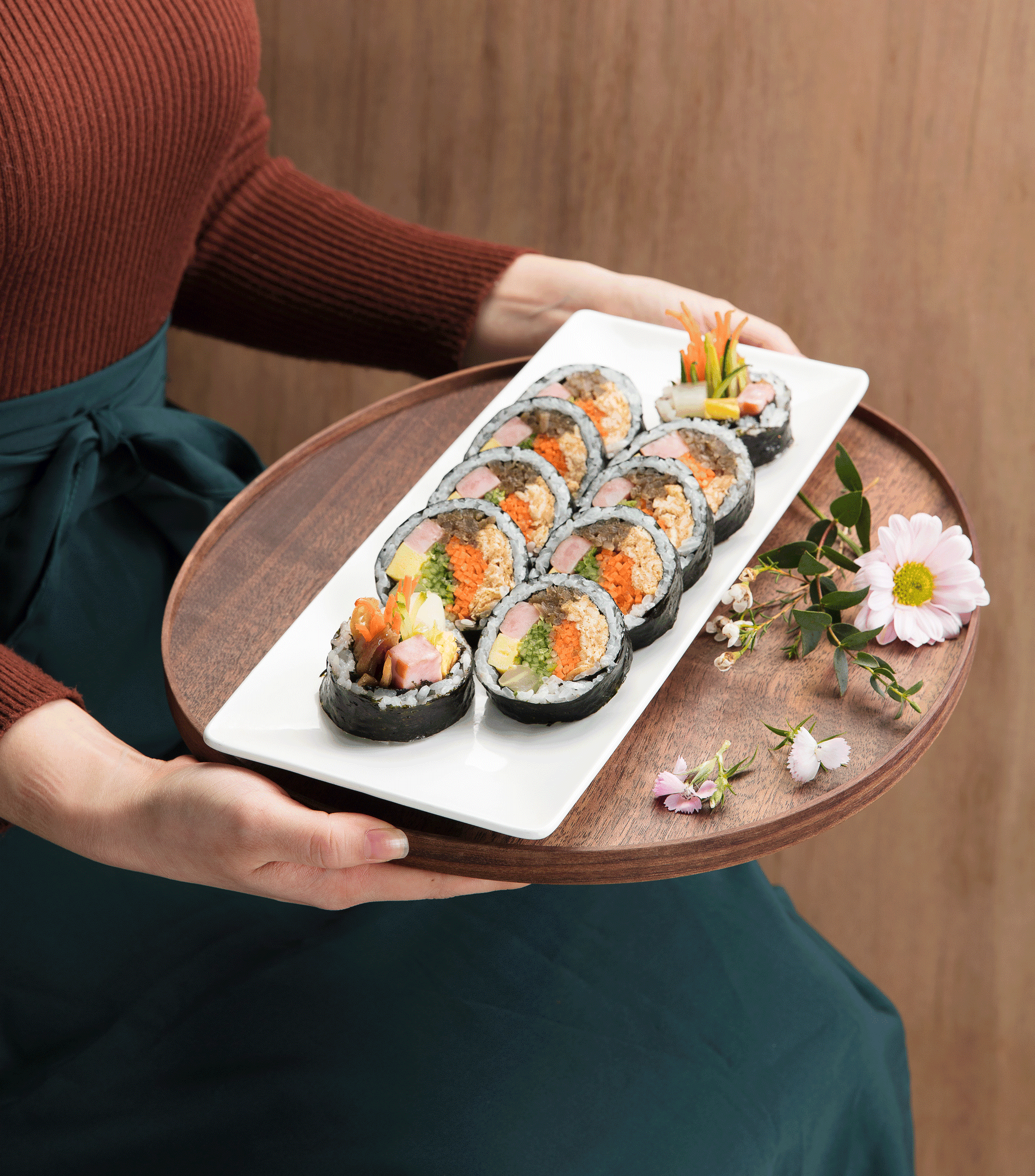 Yumsem team member plating food in a bright kitchen